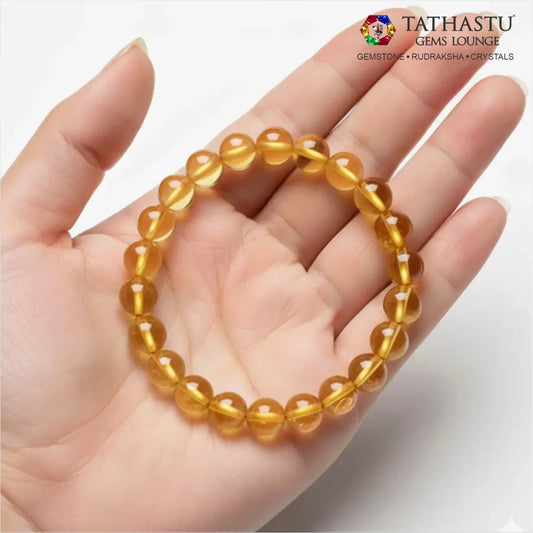 Authentic Original Citrine Bracelet at Tathastu Gems Lounge held on an open palm displaying vibrant, transparent golden-yellow beads.