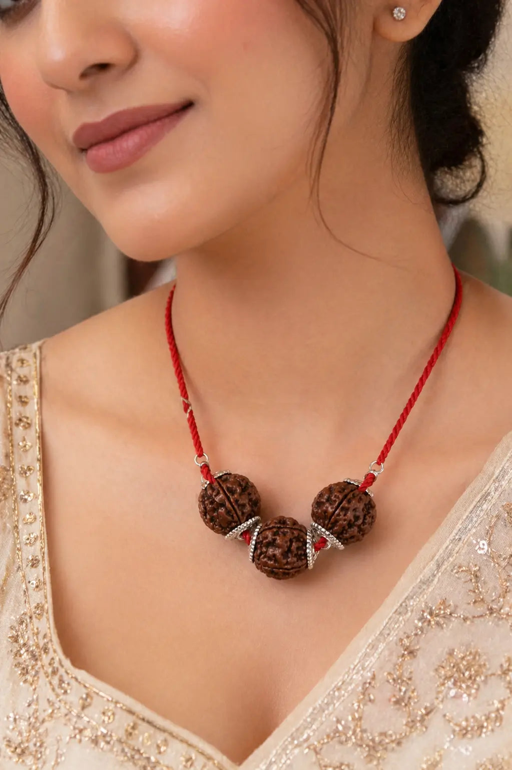 Model wearing Vidya Shakti Rudraksha Kavach pendant on red thread for concentration and intellect - Tathastu Gems