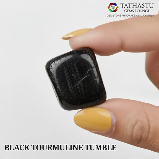 Natural polished Black Tourmaline Tumble stone held in hand for negative energy protection and grounding - Tathastu Gems Lounge