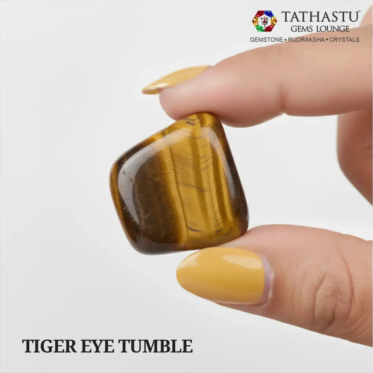 Natural polished Tiger Eye Tumble stone held in hand for courage, mental focus, and confidence - Tathastu Gems Lounge