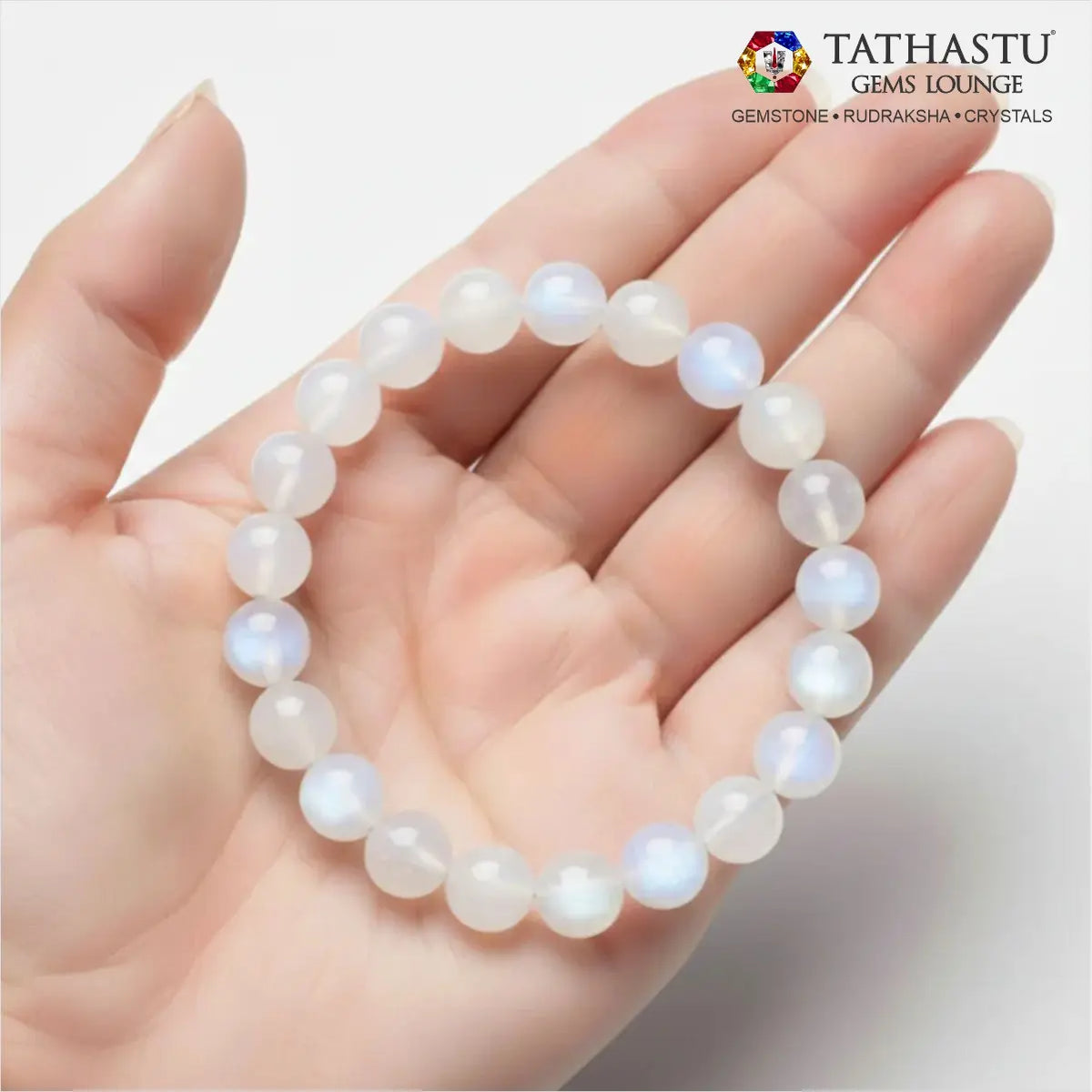 Authentic Original Moonstone Bracelet at Tathastu Gems Lounge held on an open palm displaying gentle blue sheen and white sheen beads.