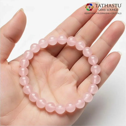 Authentic Original Rose Quartz Bracelet at Tathastu Gems Lounge held on an open palm displaying gentle translucent soft pink gemstone beads.