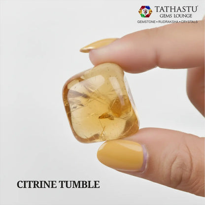 Natural polished Citrine Tumble stone held in hand for wealth attraction, self-confidence, and Solar Plexus Chakra healing - Tathastu Gems Lounge