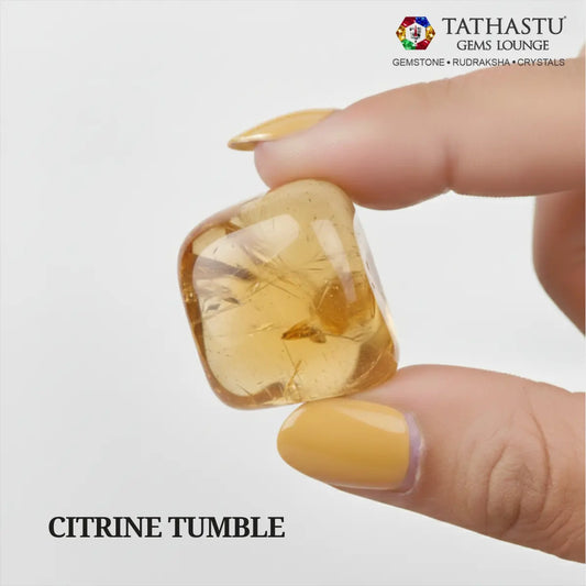 Natural polished Citrine Tumble stone held in hand for wealth attraction, self-confidence, and Solar Plexus Chakra healing - Tathastu Gems Lounge