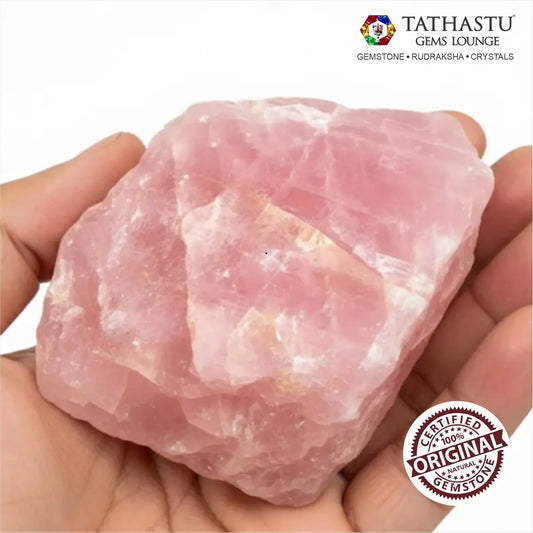 Unpolished natural Rose Quartz rough chunk held in palm showing authentic pink crystal texture and size - Tathastu Gems