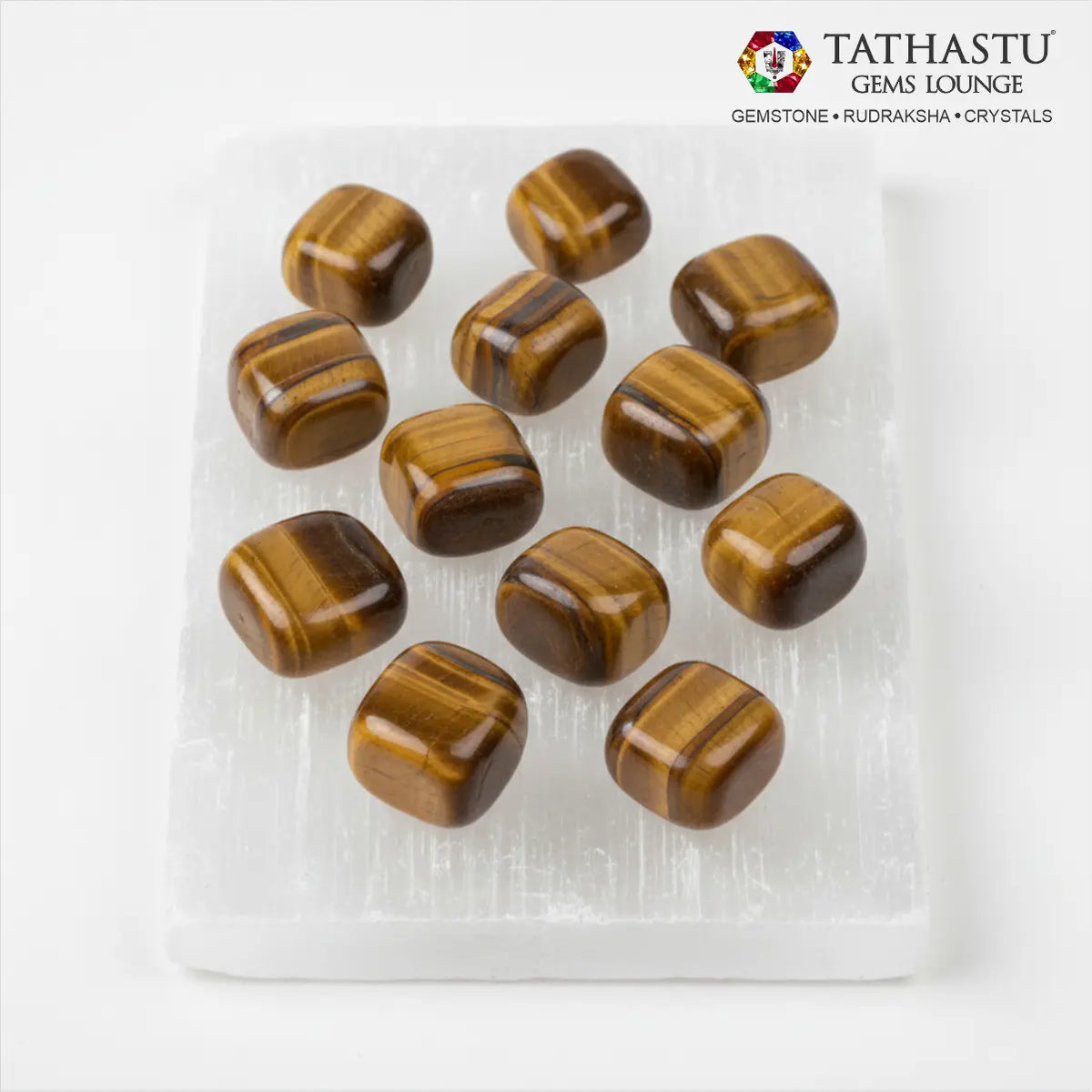 Set of original Tiger Eye Tumble stones arranged in a grid for grounding, will-power, and Solar Plexus Chakra balancing - Tathastu Gems