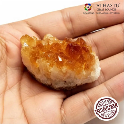 Unpolished natural Citrine rough chunk held in palm showing authentic golden yellow crystal texture and size - Tathastu Gems